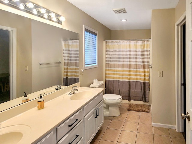 bathroom with tile patterned floors, toilet, a shower with shower curtain, and vanity