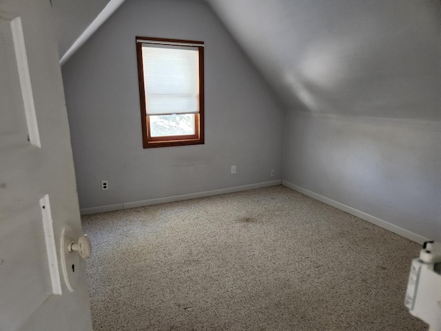 additional living space featuring lofted ceiling