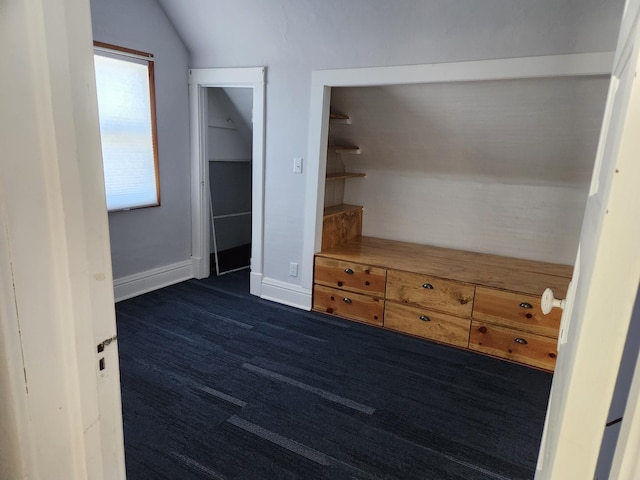 unfurnished bedroom featuring a closet and lofted ceiling