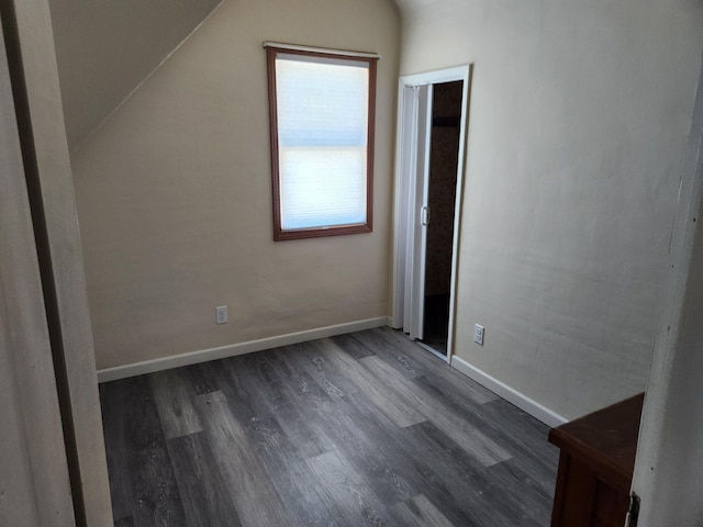 bonus room with dark hardwood / wood-style flooring and lofted ceiling