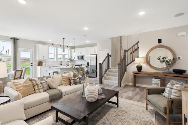 living room featuring light hardwood / wood-style floors and sink