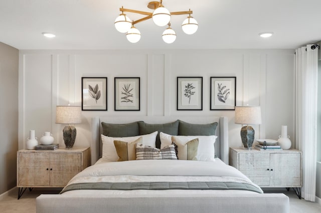 bedroom with ceiling fan with notable chandelier and carpet