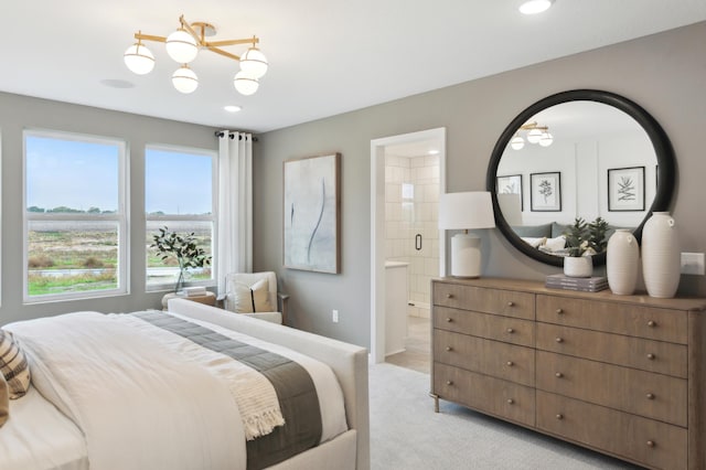 bedroom with light colored carpet and ensuite bathroom