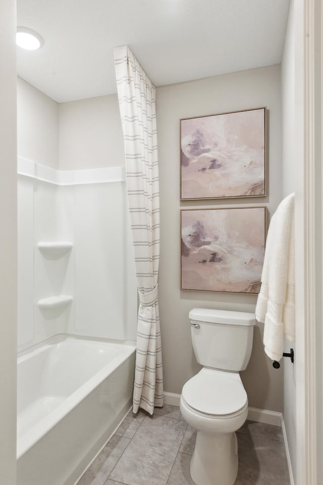 bathroom featuring shower / bath combo with shower curtain, tile patterned floors, and toilet