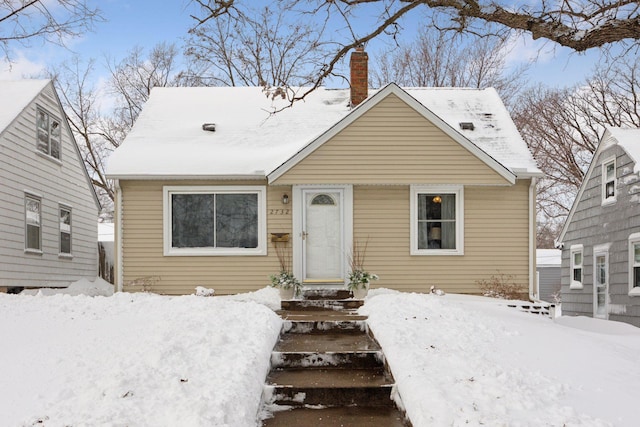 bungalow featuring a chimney