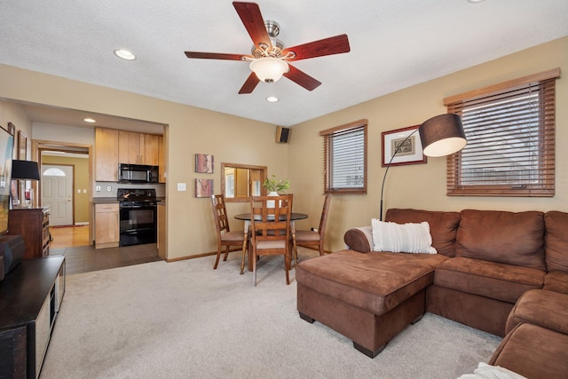 living room featuring recessed lighting, baseboards, light colored carpet, and a ceiling fan