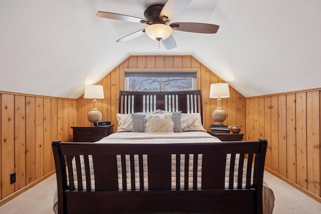 bedroom featuring lofted ceiling, carpet, and wooden walls