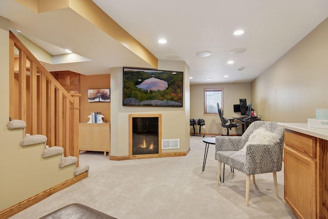 living room with visible vents, light carpet, a glass covered fireplace, recessed lighting, and baseboards