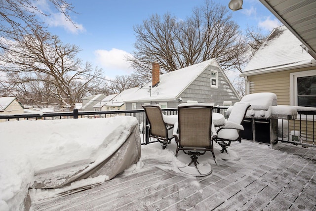 snow covered patio featuring grilling area and outdoor dining space