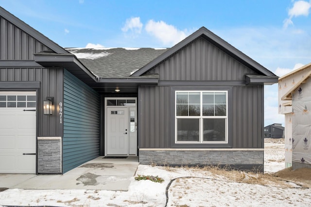 doorway to property with a garage