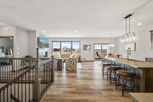 9971 14th Cir NE, Saint Michael, MN 55376 - interior space with light wood-style flooring, a textured ceiling, recessed lighting, and a chandelier