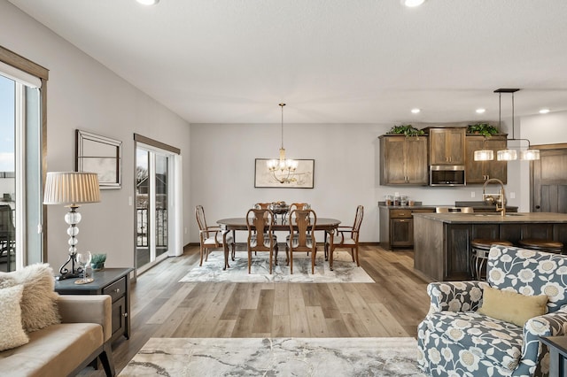 9971 14th Cir NE, Saint Michael, MN 55376 - dining space featuring light wood-style floors, a chandelier, recessed lighting, and baseboards