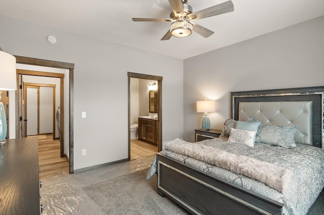 9971 14th Cir NE, Saint Michael, MN 55376 - bedroom with light wood finished floors, baseboards, a ceiling fan, and ensuite bath
