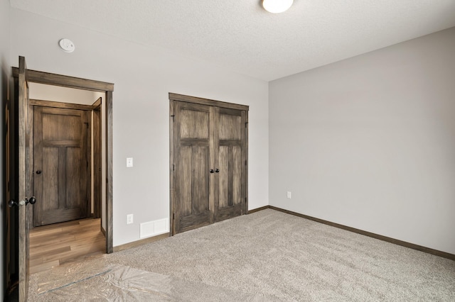9971 14th Cir NE, Saint Michael, MN 55376 - unfurnished bedroom with carpet, baseboards, a closet, and a textured ceiling