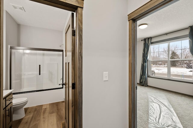 9971 14th Cir NE, Saint Michael, MN 55376 - full bathroom featuring toilet, vanity, shower / bath combination with glass door, and wood finished floors