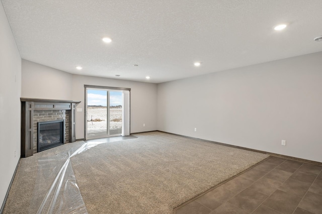 9971 14th Cir NE, Saint Michael, MN 55376 - unfurnished living room with recessed lighting, a brick fireplace, baseboards, and a textured ceiling