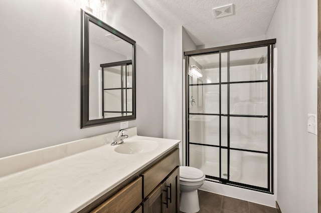9971 14th Cir NE, Saint Michael, MN 55376 - full bath with vanity, a shower stall, toilet, a textured ceiling, and tile patterned flooring