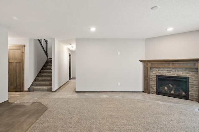 9971 14th Cir NE, Saint Michael, MN 55376 - unfurnished living room featuring stairs, a fireplace, baseboards, a textured ceiling, and recessed lighting