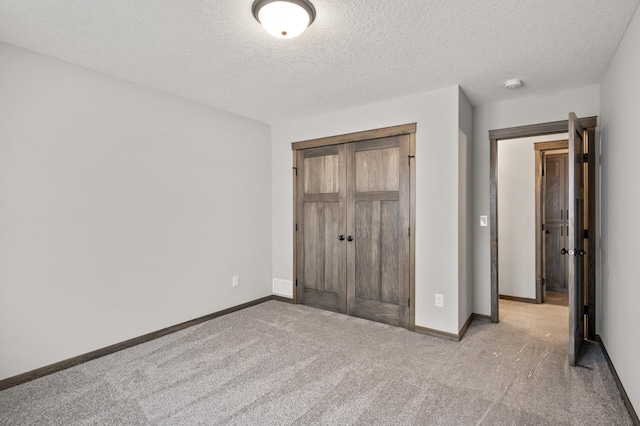 9971 14th Cir NE, Saint Michael, MN 55376 - unfurnished bedroom featuring carpet, a closet, a textured ceiling, and baseboards