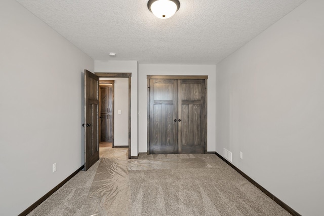 9971 14th Cir NE, Saint Michael, MN 55376 - unfurnished bedroom with light colored carpet, baseboards, a closet, and a textured ceiling