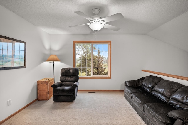 carpeted living room featuring lofted ceiling, a textured ceiling, and ceiling fan