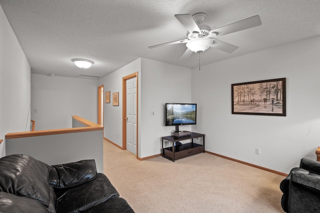 carpeted living room with ceiling fan and a textured ceiling