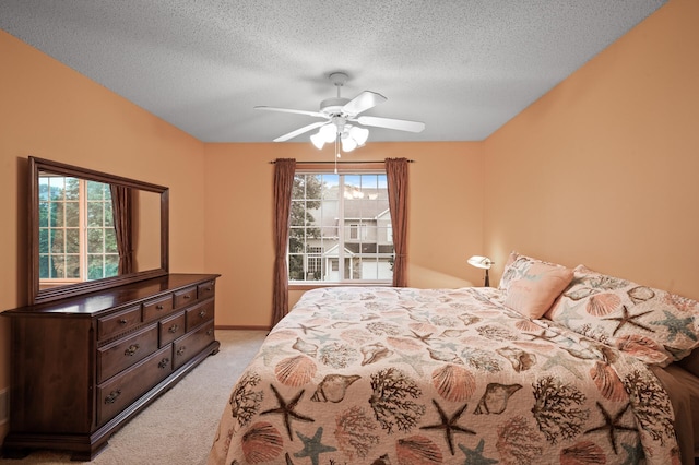 carpeted bedroom with a textured ceiling and ceiling fan