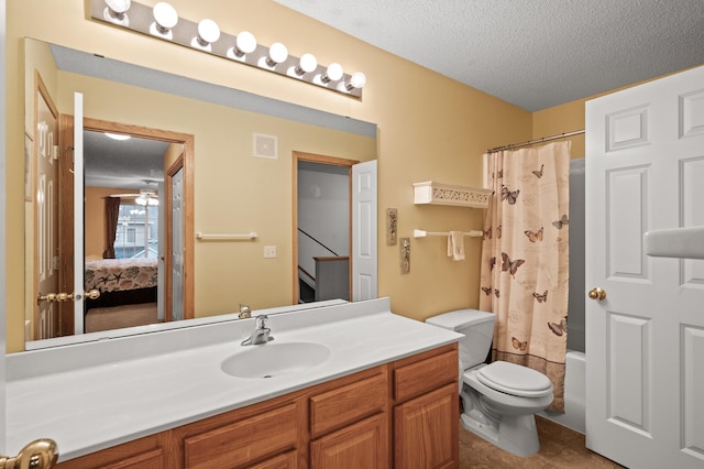 full bathroom featuring a textured ceiling, toilet, vanity, and shower / tub combo with curtain