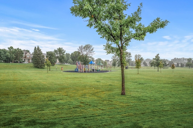 surrounding community featuring a playground and a lawn