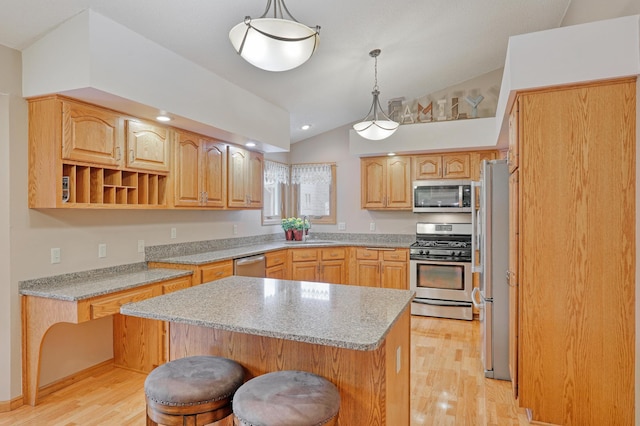 kitchen with pendant lighting, a breakfast bar, stainless steel appliances, vaulted ceiling, and light wood-type flooring