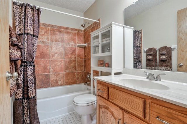 full bathroom with shower / bath combo, vanity, a textured ceiling, tile patterned floors, and toilet