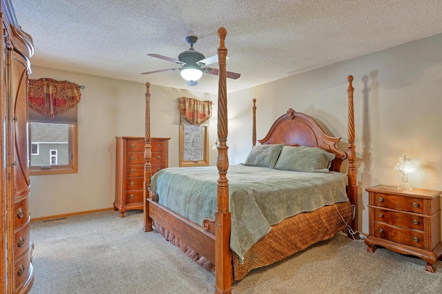 bedroom featuring ceiling fan, light carpet, and a textured ceiling