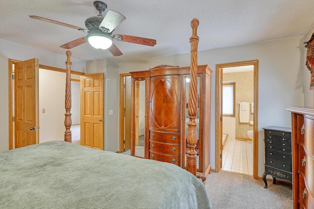 bedroom featuring ensuite bath, a textured ceiling, ceiling fan, and carpet