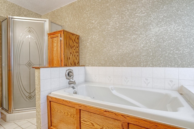 bathroom with tile patterned flooring, a bathing tub, lofted ceiling, and a textured ceiling