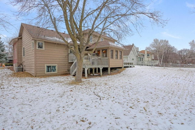 snow covered property featuring central AC