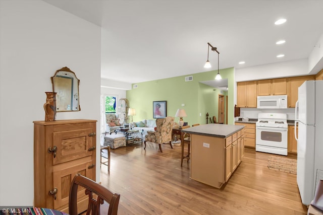 kitchen with pendant lighting, white appliances, a center island, light hardwood / wood-style floors, and a breakfast bar area