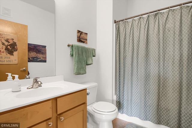 bathroom featuring vanity, toilet, and a shower with curtain