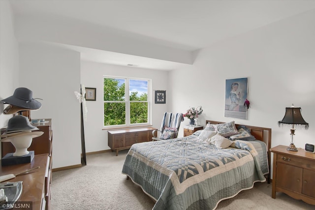 bedroom featuring light carpet