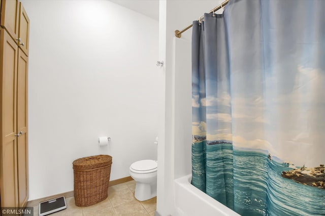 bathroom with shower / bath combo with shower curtain, toilet, and tile patterned flooring