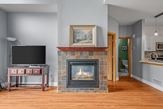 living room featuring hardwood / wood-style floors and a fireplace