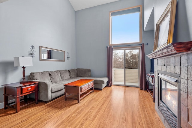 living room with light hardwood / wood-style flooring and a high ceiling