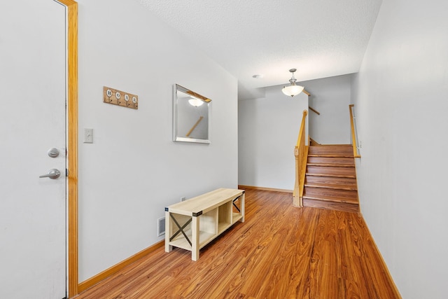 interior space with light hardwood / wood-style floors and a textured ceiling