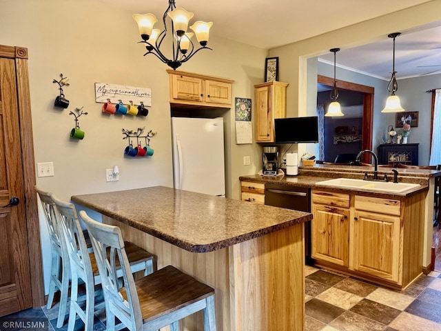 kitchen featuring pendant lighting, sink, kitchen peninsula, and white refrigerator