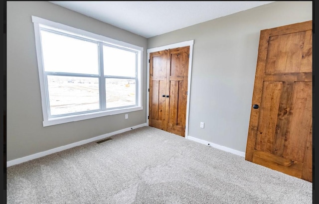 unfurnished bedroom with a closet and carpet flooring