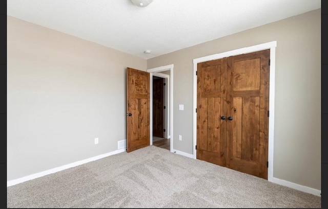 unfurnished bedroom featuring a closet and carpet flooring