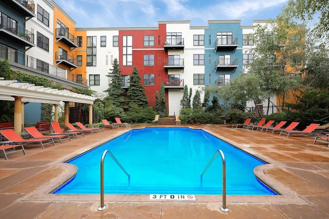 view of swimming pool featuring a patio area and a pergola