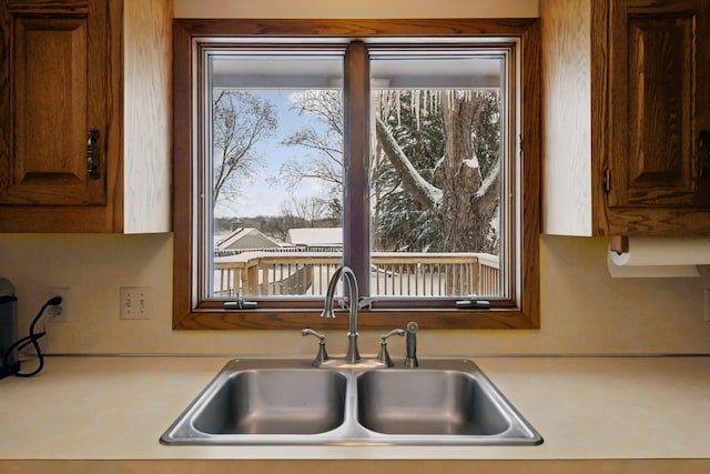 kitchen featuring light countertops and a sink