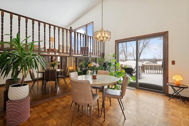 dining area with a notable chandelier and high vaulted ceiling