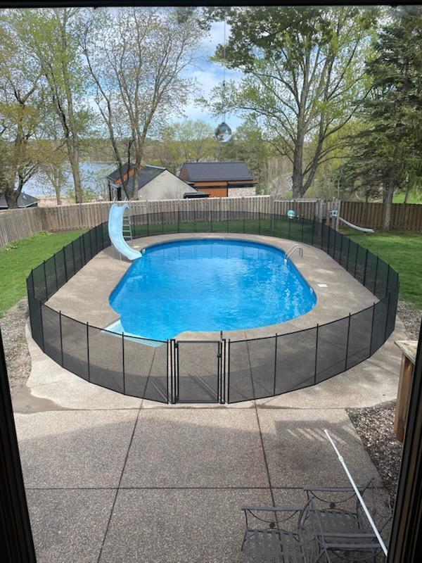 view of pool featuring a fenced in pool, a patio, a water slide, and a fenced backyard