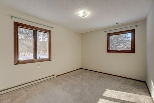 unfurnished room with a baseboard heating unit, a textured ceiling, and light colored carpet